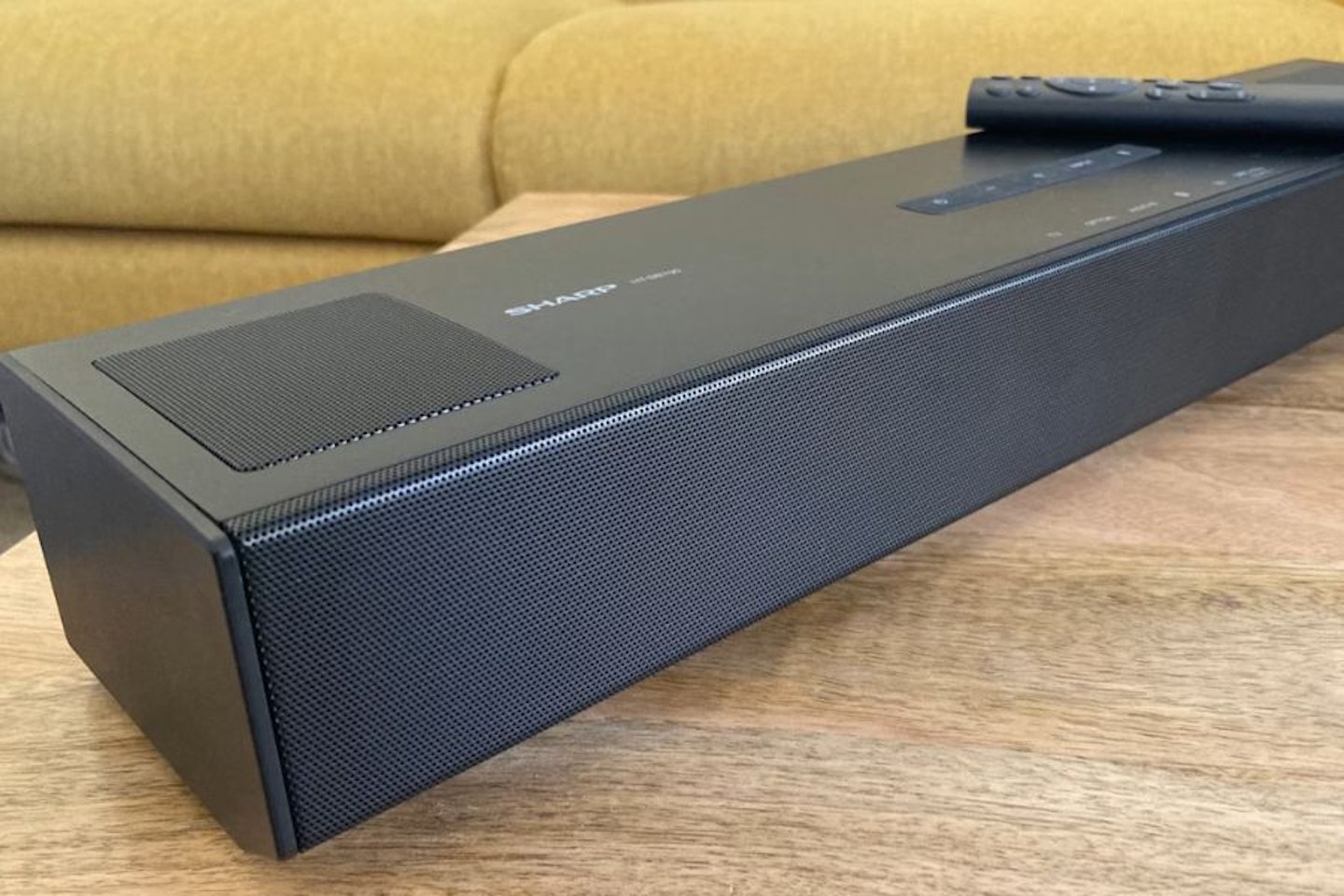 Best compact budget soundbar. Sharp HT-SB700 Soundbar and remote on a table. Best budget soundbars.