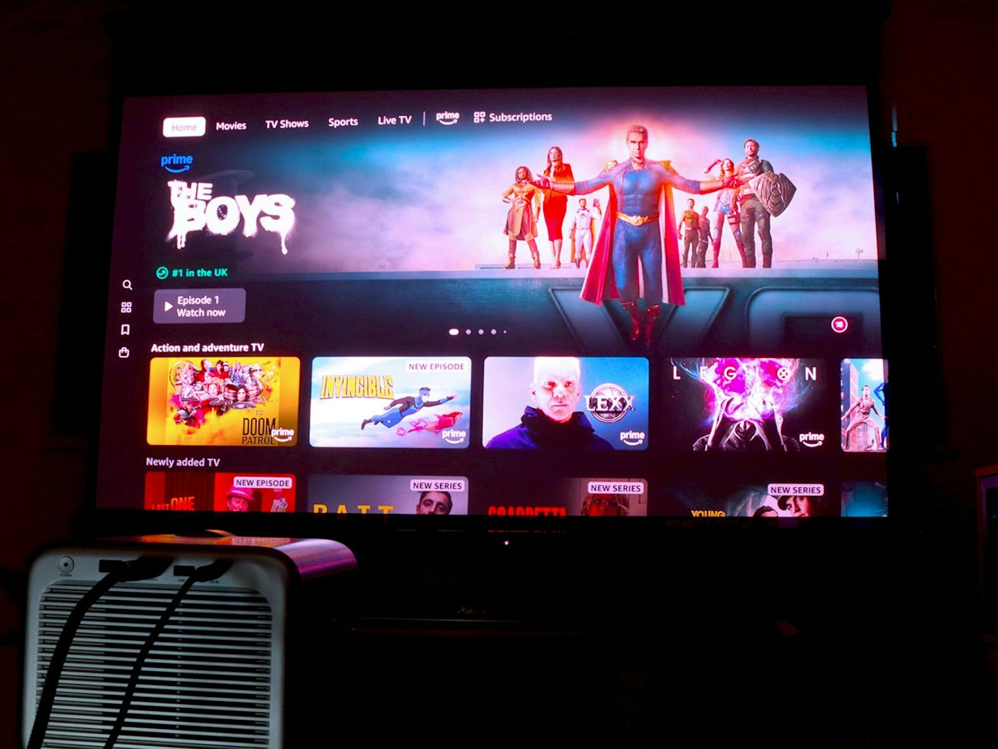 Hisense M2 Pro projector and popcorn on a table - projecting Android TV Amazon Prime App with The Boys